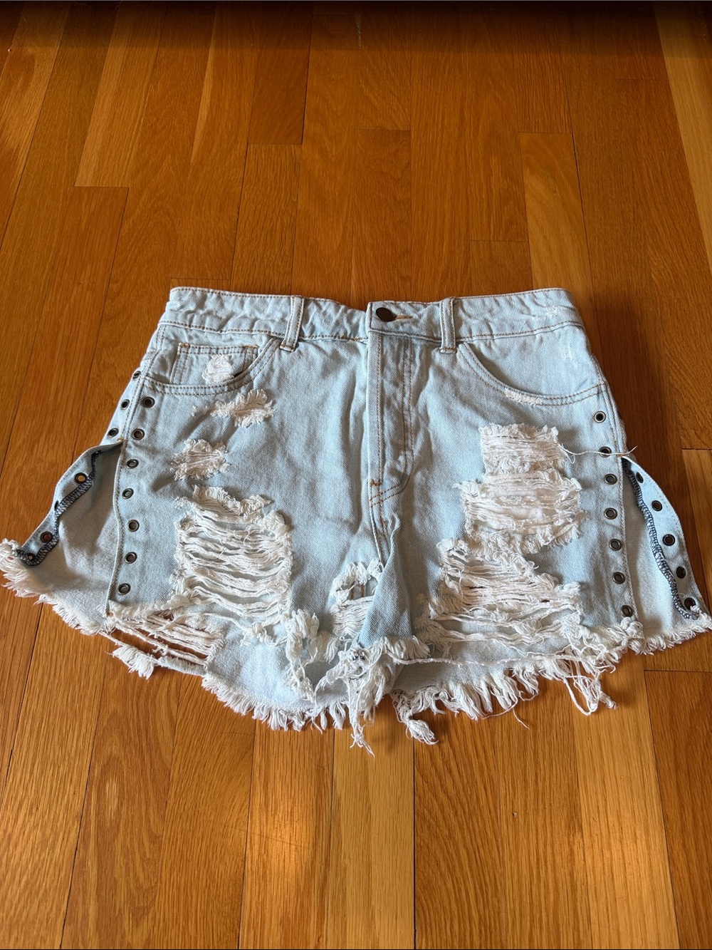 High-Rise Light Blue Distressed Denim Shorts with Eyelet Trim